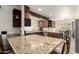 Spacious kitchen with granite countertops and wood cabinets, perfect for cooking and entertaining at 6232 N 88Th Ave, Glendale, AZ 85305