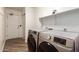 Well-lit laundry room with a modern Samsung washer and dryer set, storage shelf, and a neutral color palette at 6232 N 88Th Ave, Glendale, AZ 85305