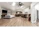 Open-concept living space with vaulted ceilings, skylights, wood floors, fireplace, and kitchen view at 6232 N 88Th Ave, Glendale, AZ 85305
