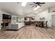 Open-concept living space with vaulted ceilings, skylights, wood floors, fireplace, and kitchen view at 6232 N 88Th Ave, Glendale, AZ 85305