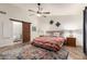 Main bedroom with decorative accents and barn door leading to bathroom at 6232 N 88Th Ave, Glendale, AZ 85305