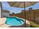 Inviting backyard pool with clean water, an umbrella, and a well-maintained deck, perfect for summer relaxation at 6232 N 88Th Ave, Glendale, AZ 85305