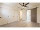 Bright bedroom featuring wood flooring, a sliding barn door to the bathroom, and ample closet space at 6544 N 7Th Ave # 14, Phoenix, AZ 85013