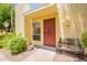 Inviting front entrance featuring a secure, decorative red door and cozy bench seating, offering a warm welcome at 6544 N 7Th Ave # 14, Phoenix, AZ 85013