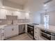 Modern kitchen featuring white cabinets, stainless steel appliances and fixtures, and quartz countertops with breakfast bar at 6544 N 7Th Ave # 14, Phoenix, AZ 85013