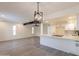 Spacious open floor plan with stylish light fixture, wood flooring, and an inviting kitchen area at 6544 N 7Th Ave # 14, Phoenix, AZ 85013
