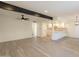 Spacious living room featuring modern flooring, a dark beam, and an open layout flowing into the bright kitchen at 6544 N 7Th Ave # 14, Phoenix, AZ 85013