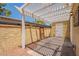 Outdoor patio area has white pergola, stucco walls, and secure access door at 6544 N 7Th Ave # 14, Phoenix, AZ 85013