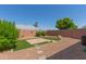 Well-maintained backyard featuring gravel, a stone patio, and artificial turf at 6610 E University Dr # 2, Mesa, AZ 85205