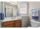 Bright bathroom featuring a wood vanity, neutral walls, and decorative butterfly accents at 6610 E University Dr # 2, Mesa, AZ 85205