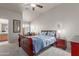 Vaulted ceiling in bedroom features a ceiling fan and ensuite bathroom with vanity and a window at 6610 E University Dr # 2, Mesa, AZ 85205