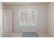 Empty bedroom with neutral walls, carpeted floors, and a window with white plantation shutters at 6610 E University Dr # 2, Mesa, AZ 85205