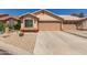 Inviting single-story home featuring a two-car garage and low-maintenance desert landscaping at 6610 E University Dr # 2, Mesa, AZ 85205
