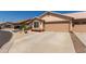 Single-story home with a two-car garage and desert landscaping for easy maintenance at 6610 E University Dr # 2, Mesa, AZ 85205