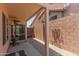 Covered patio with heater and view of brick fence and decorative items in the backyard at 6610 E University Dr # 2, Mesa, AZ 85205