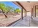 Covered back patio with decorative rock landscaping, seating and a playhouse at 7532 E Sierra Morena Cir, Mesa, AZ 85207