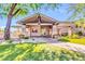 Elegant clubhouse entrance with manicured lawn and landscaped grounds at 7532 E Sierra Morena Cir, Mesa, AZ 85207