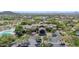 Aerial view of a stunning clubhouse with a tile roof, surrounded by lush landscaping and a sparkling pool at 7532 E Sierra Morena Cir, Mesa, AZ 85207