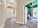 Welcoming foyer with tiled floor, leading to a room with a colorful rug and chair at 7532 E Sierra Morena Cir, Mesa, AZ 85207