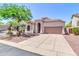 Inviting single-story home with landscaped front yard, desert plants, and a two-car garage at 7532 E Sierra Morena Cir, Mesa, AZ 85207