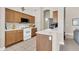 Functional kitchen with wooden cabinetry, white appliances, and a breakfast bar at 7532 E Sierra Morena Cir, Mesa, AZ 85207