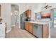 Well-lit kitchen featuring tile floors, stainless steel appliances, and a breakfast bar overlooking the living area at 7532 E Sierra Morena Cir, Mesa, AZ 85207