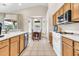 Bright kitchen with white countertops, wood cabinets, and an adjacent dining area at 7532 E Sierra Morena Cir, Mesa, AZ 85207
