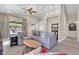 Cozy living room boasts a sectional sofa, wooden coffee table, and backyard views at 7532 E Sierra Morena Cir, Mesa, AZ 85207