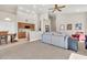 Open-concept living room with carpet flooring, light gray sofa, and kitchen view at 7532 E Sierra Morena Cir, Mesa, AZ 85207