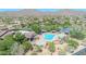 Overhead view of an inviting community pool featuring lap lanes and spa nestled among lush greenery with mountain views at 7532 E Sierra Morena Cir, Mesa, AZ 85207