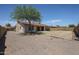 The backyard with a mature tree, lawn and gravel area at 7549 W Yucca St, Peoria, AZ 85345