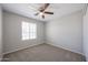 Neutral bedroom featuring carpet, ceiling fan, window, and closet at 7549 W Yucca St, Peoria, AZ 85345