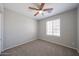 Comfortable bedroom with neutral walls, carpet, ceiling fan, and window at 7549 W Yucca St, Peoria, AZ 85345