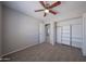 Neutral bedroom featuring a ceiling fan, carpet and closet with built-in shelving at 7549 W Yucca St, Peoria, AZ 85345