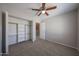 Bedroom with carpet, ceiling fan, window, and closet with shelving at 7549 W Yucca St, Peoria, AZ 85345