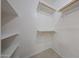 Walk-in closet with shelving and neutral tile flooring at 7549 W Yucca St, Peoria, AZ 85345