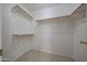 Walk in closet with shelves and neutral tile flooring at 7549 W Yucca St, Peoria, AZ 85345
