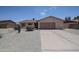 Single-story home with desert landscaping, gravel yard, and a two-car garage at 7549 W Yucca St, Peoria, AZ 85345