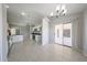 Open concept kitchen with white cabinets, tile flooring, modern lighting, and stainless steel appliances at 7549 W Yucca St, Peoria, AZ 85345