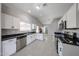 Stylish kitchen with stainless steel appliances, white cabinets, and modern black countertops at 7549 W Yucca St, Peoria, AZ 85345
