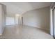 Open living room with tile floors, coat closet, and neutral paint at 7549 W Yucca St, Peoria, AZ 85345