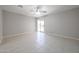 Living room featuring neutral tile floors, ceiling fan and glass sliding door at 7549 W Yucca St, Peoria, AZ 85345