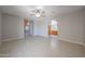Living room featuring neutral tile floors, ceiling fan and an arched entry at 7549 W Yucca St, Peoria, AZ 85345