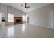 Cozy living room showcasing a brick fireplace, tile flooring, and a ceiling fan at 7549 W Yucca St, Peoria, AZ 85345