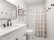 Cozy, renovated bathroom with a shower/tub, white cabinets, matte black faucet, and vintage floor tiles at 8007 E Del Tesoro Dr, Scottsdale, AZ 85258