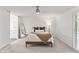 Bright, airy bedroom with ceiling fan, large window, and ensuite bathroom creates a relaxing retreat at 8007 E Del Tesoro Dr, Scottsdale, AZ 85258