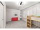 This bedroom features a loft bed, vibrant dresser, shelving unit, and shuttered windows at 8007 E Del Tesoro Dr, Scottsdale, AZ 85258