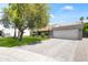 Exterior view of a modern home with well-maintained landscaping and a brick driveway at 8007 E Del Tesoro Dr, Scottsdale, AZ 85258
