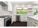 Bright modern kitchen with stainless steel appliances, white cabinetry, and backyard views at 8007 E Del Tesoro Dr, Scottsdale, AZ 85258