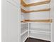 Well-organized pantry features custom wood shelving and a microwave for convenient food storage at 8007 E Del Tesoro Dr, Scottsdale, AZ 85258